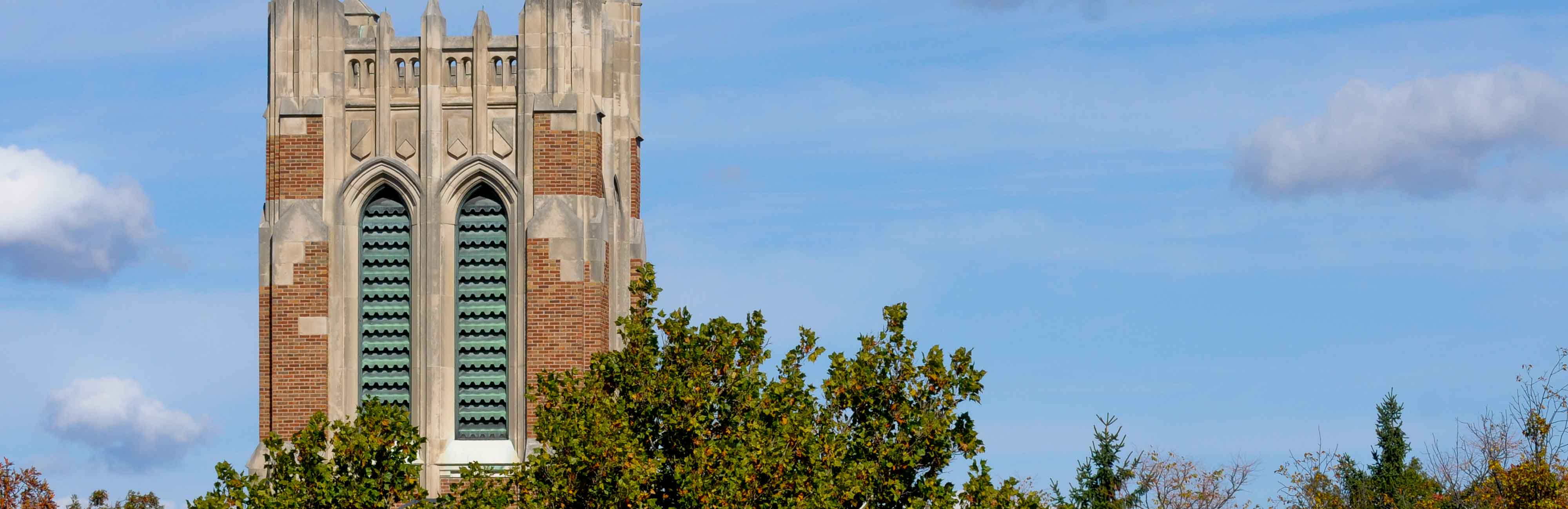 Image of the top of Beaumont Tower set against a blue sky.